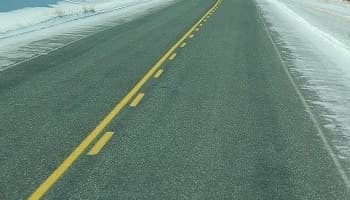 straight yellow line with broken yellow line on road